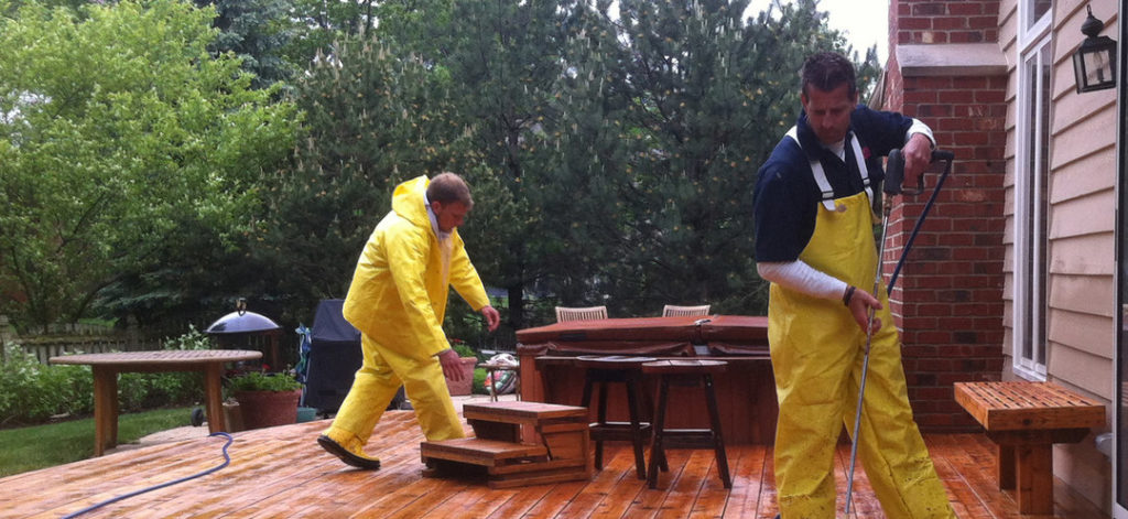 deck medic yellow overalls fixing deck